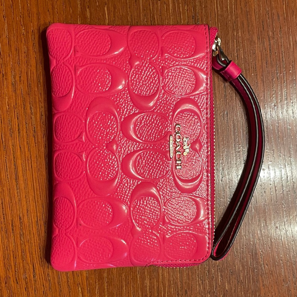 Neon pink Coach wristlet